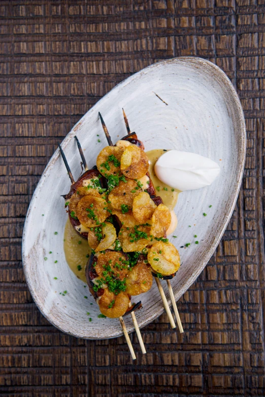 a close up of a plate of food on a table, skewer, clumps of bananas, nomad, thumbnail