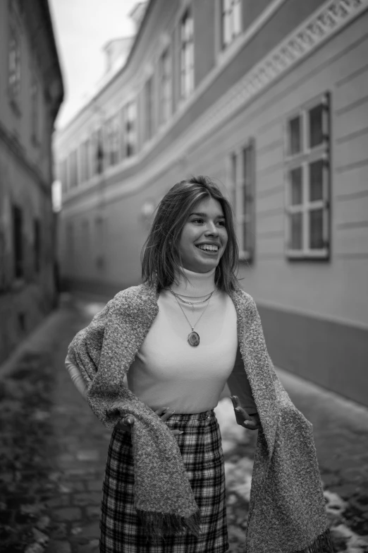 a black and white photo of a woman smiling, a black and white photo, by Tamas Galambos, pexels contest winner, renaissance, wearing jacket and skirt, cute young woman, photo of džesika devic, in town