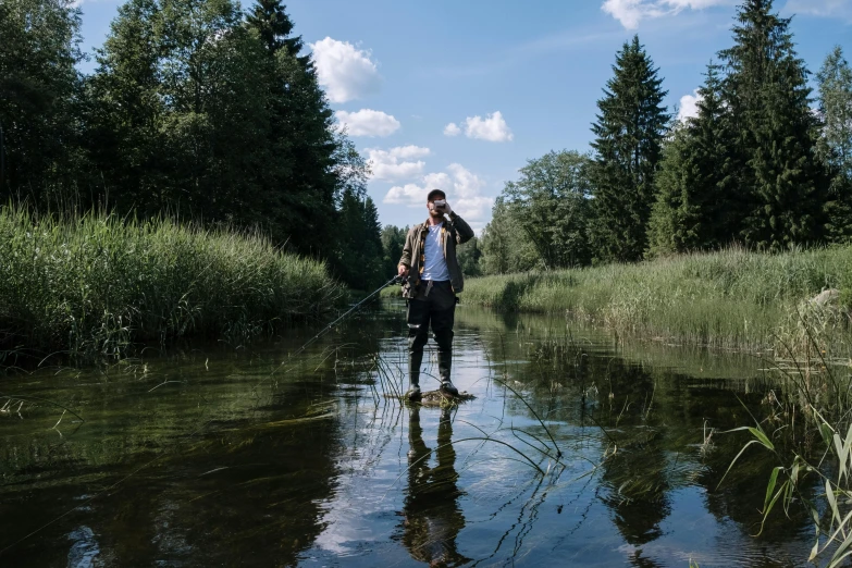 a couple of people standing on top of a river, fishing, jakub kasper, photo of a man, lookbook