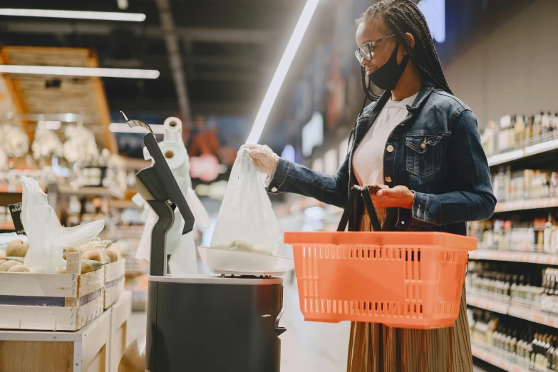 a woman wearing a face mask while shopping in a grocery store, pexels contest winner, figuration libre, with a robotic arm, dark-skinned, 🦩🪐🐞👩🏻🦳, skies behind