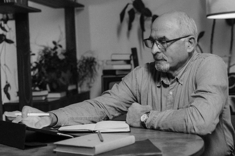 a man sitting at a table working on a laptop, a portrait, by István Csók, brian jacques, catalog photo, stanisław, andreas rochas