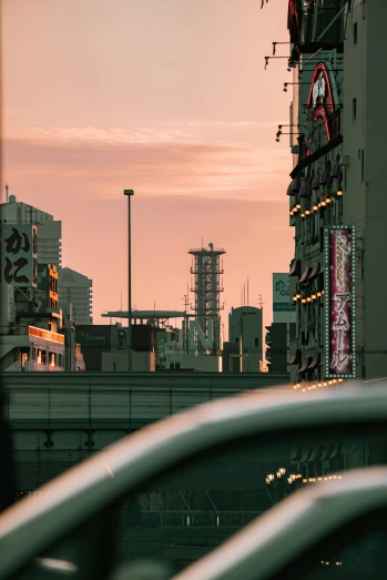 a city street filled with lots of traffic next to tall buildings, inspired by Yoshio Markino, unsplash contest winner, brutalism, looking out at a sunset, japanese neon signs, morning detail, rooftop