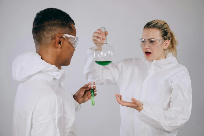 a couple of people standing next to each other, trending on pexels, analytical art, experimenting in her science lab, wearing only a green robe, pouring techniques, gif