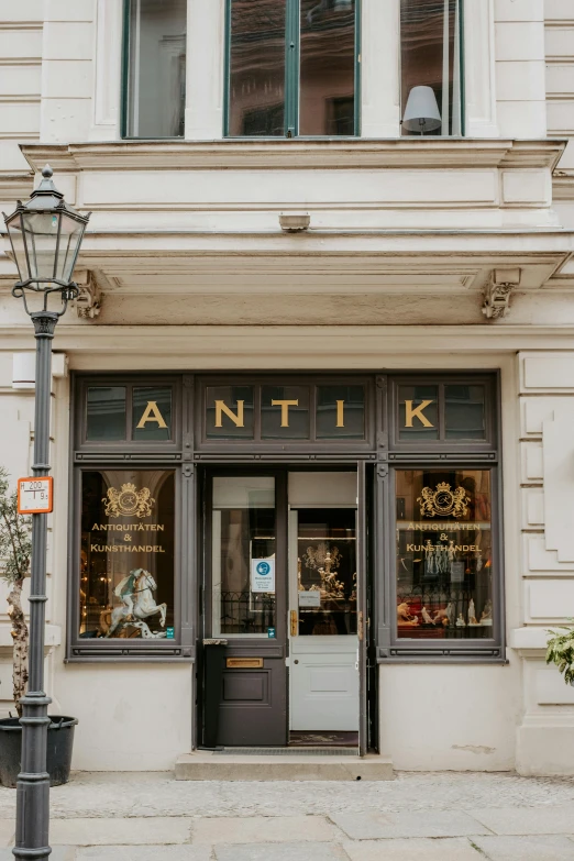 the front of an antique store on a city street, by Konrad Witz, anato finnstark and kelogsloops, entrance, vanta black, restaurant