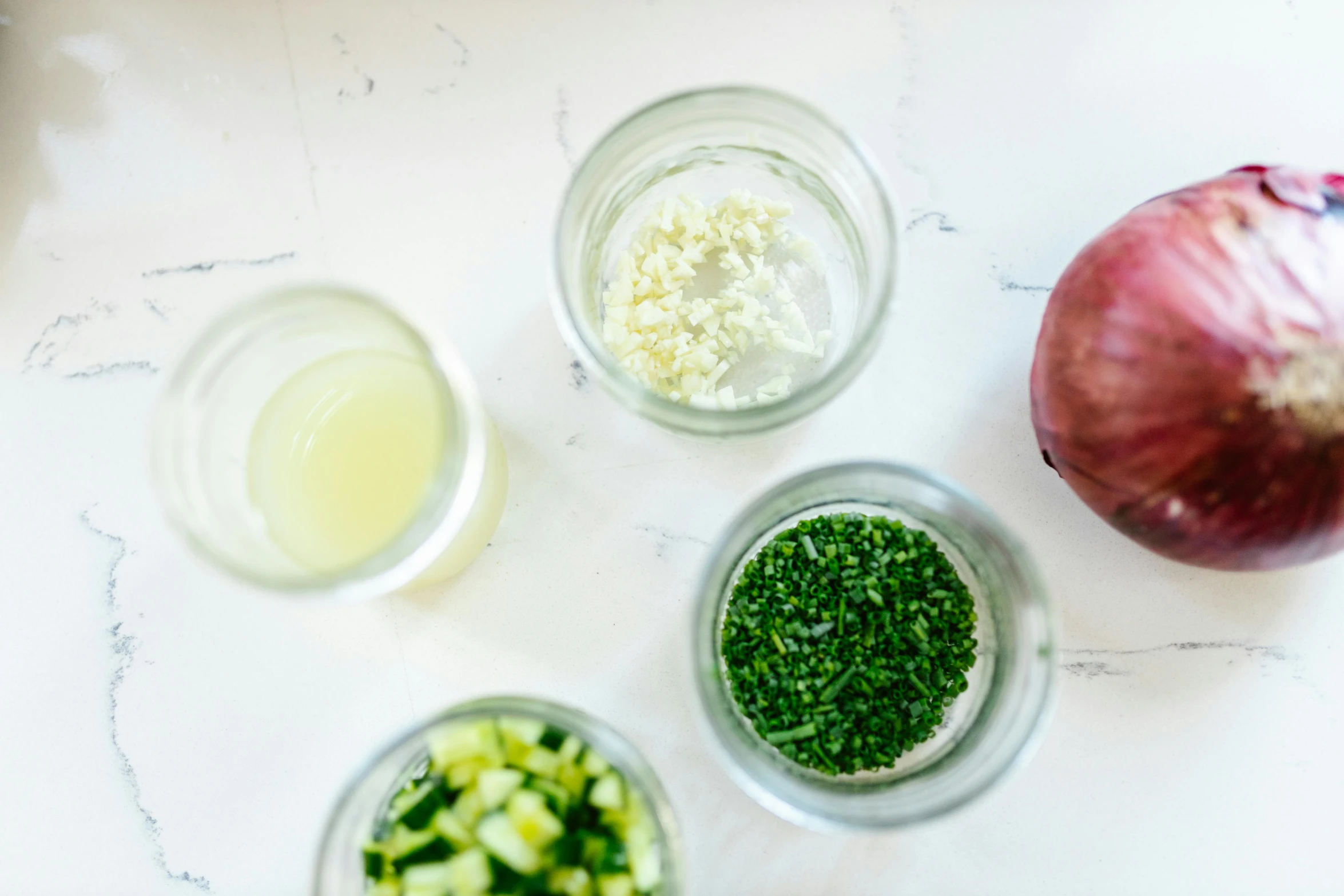 a table topped with bowls filled with different types of food, green eays, inside a glass jar, mash potatoes, ready to model