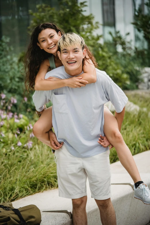 a man carrying a woman on his back, inspired by John Luke, trending on pexels, wearing a light blue shirt, bo chen, non binary model, turning her head and smiling