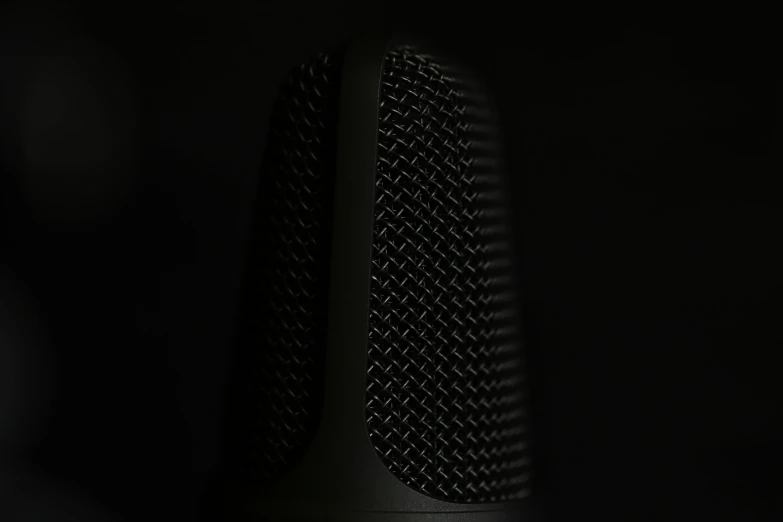 a close up of a microphone with a black background, a stipple, unsplash, digital art, black plastic, shroud, vertical wallpaper, hibernation capsule close-up