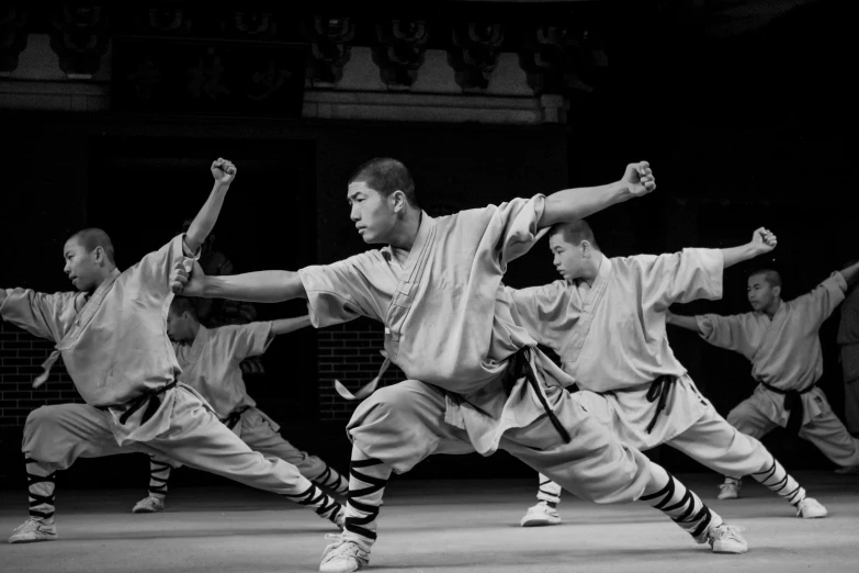 a group of men standing on top of a stage, inspired by Ma Quan, pexels contest winner, arabesque, fisting monk, ready to strike, [ theatrical ], bo xun ling