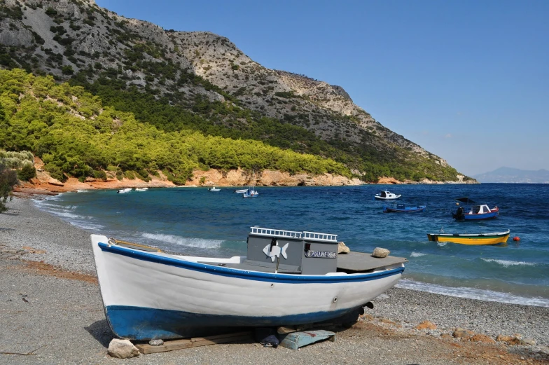 a boat sitting on top of a beach next to the ocean, a photo, les nabis, piroca, avatar image, hydra, realistic »