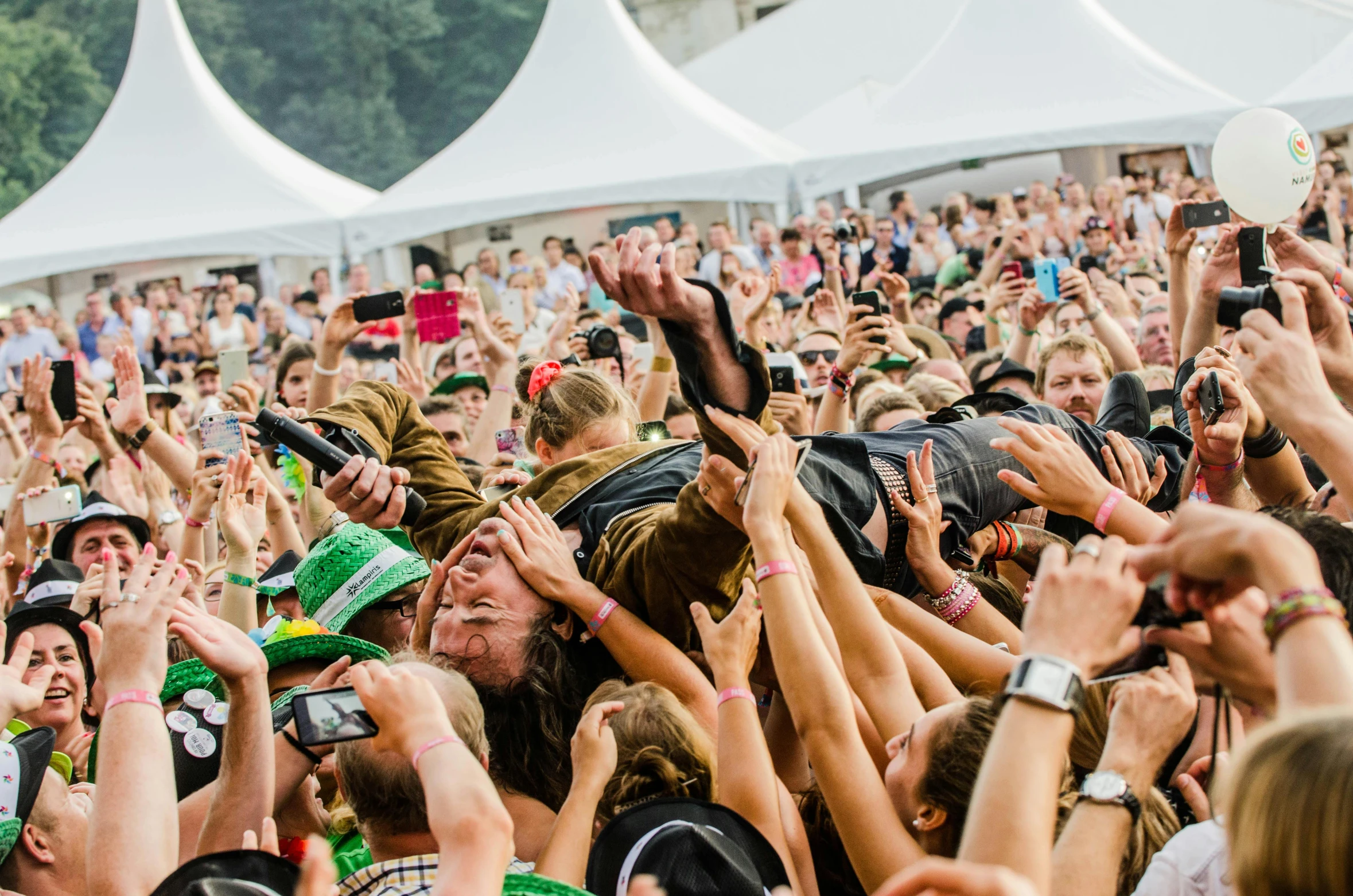 a crowd of people with their hands in the air, by Niko Henrichon, happening, headbanging, lying down, gigapixel photo, scenery