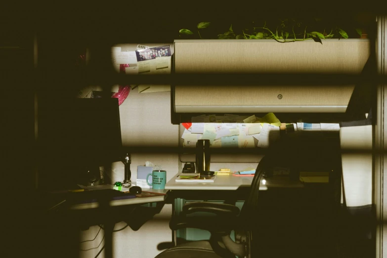 a desk with a computer monitor sitting on top of it, a photocopy, unsplash, process art, pipe jungle, flickering fluorescent lights, spying, artstation hq