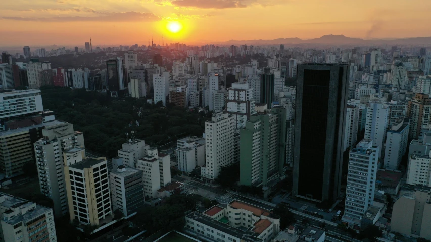 an aerial view of a city at sunset, by Ceferí Olivé, pexels contest winner, realism, avenida paulista, low quality photo, aerial footage, helio oiticica