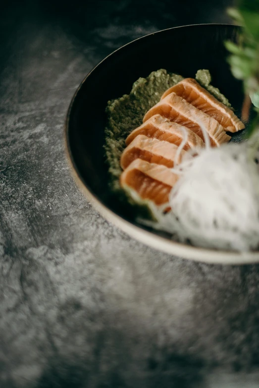 a close up of a bowl of food on a table, inspired by Nishida Shun'ei, unsplash contest winner, purism, layered texture, salmon, noodles, green