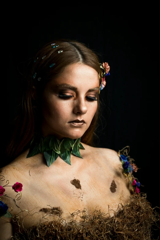 a close up of a woman wearing a dress with flowers on it, inspired by Hans Baldung, bodypaint, covered in leaves, non binary model, artist wearing dirty