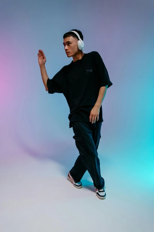 a man in a black shirt and headphones dancing, inspired by Russell Dongjun Lu, happening, wearing cargo pants, non binary model, official store photo, dolman