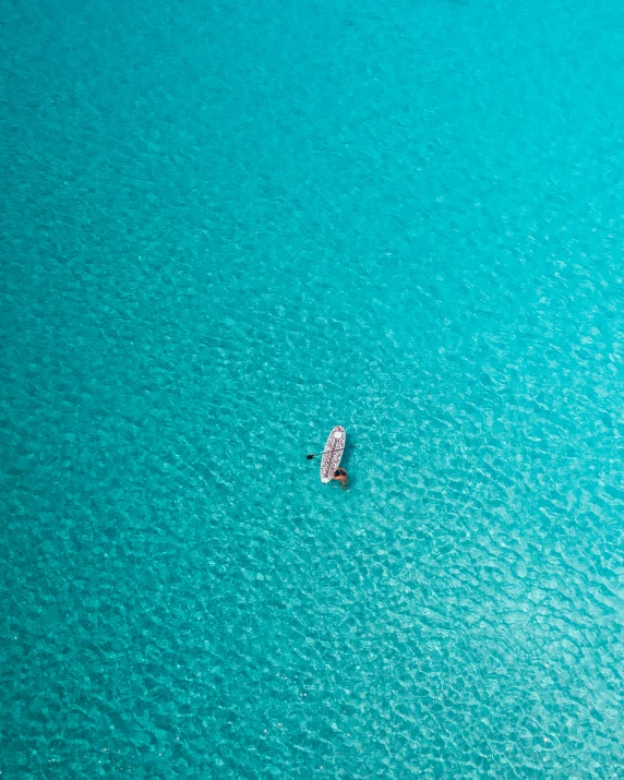 a small boat floating in the middle of a large body of water, unsplash contest winner, turquoise water, thumbnail, calmly conversing 8k, a high angle shot