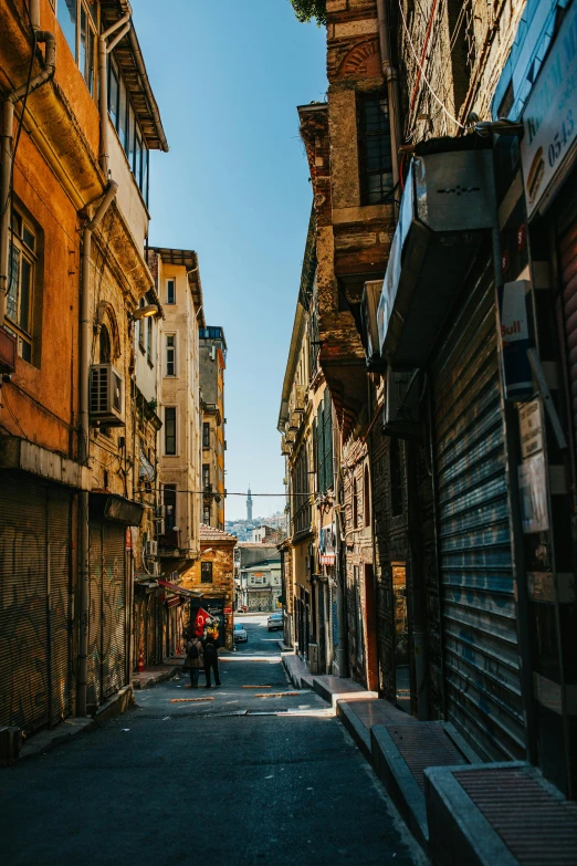 a narrow street in an old european city, an album cover, by Ibrahim Kodra, pexels contest winner, fallout style istanbul, sunny day time, shanty townships, unsplash photography