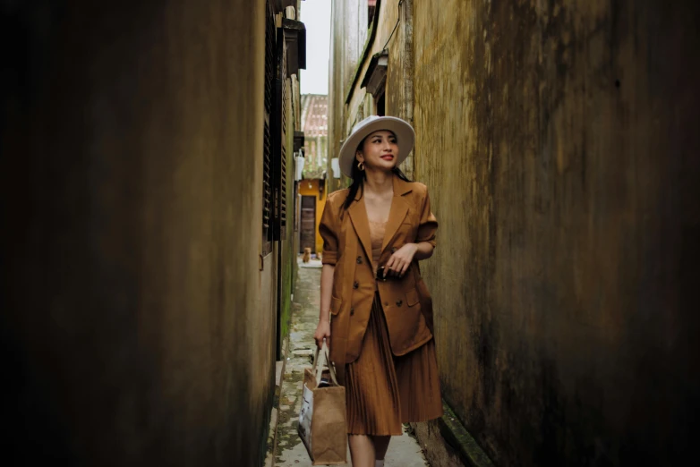 a woman is walking down a narrow alleyway, pexels contest winner, renaissance, wearing a worn out brown suit, in style of lam manh, caracter with brown hat, sophisticated young woman