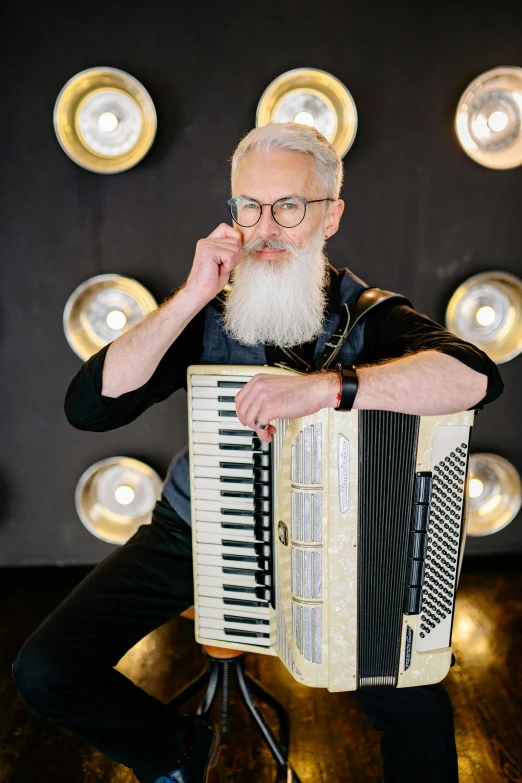 a man with a beard playing an accordion, silver hair and beard, sascha schneider, promo photo, portrait of tall