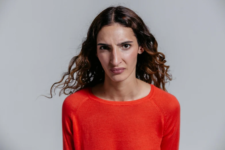 a woman in a red shirt posing for a picture, an album cover, by David Begbie, pexels contest winner, antipodeans, frustrated face, reza afshar, acting headshot, very thin
