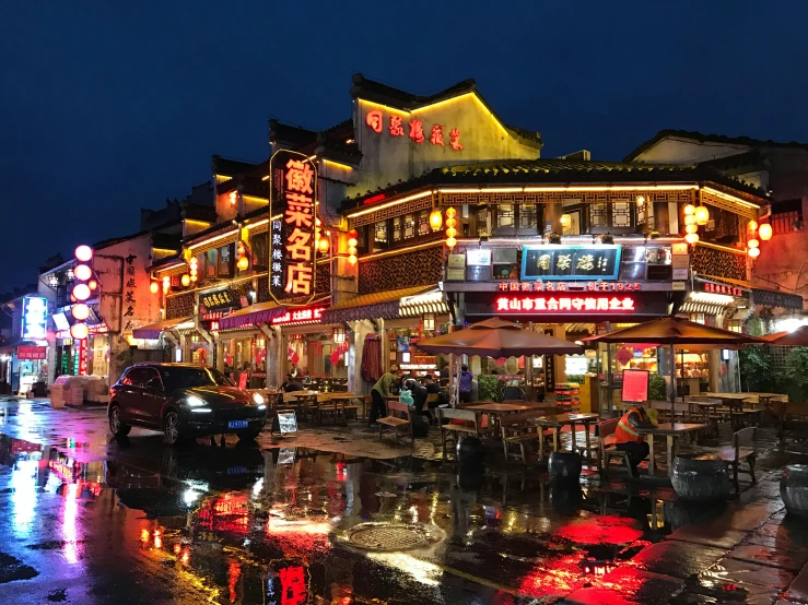 a city street filled with lots of traffic at night, chinese architecture, after the rain, neon signs, slide show