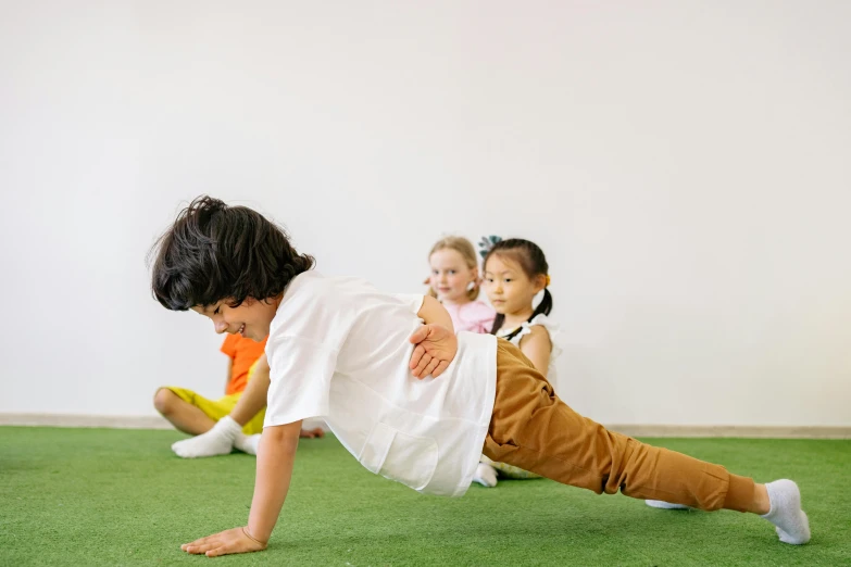 a group of children playing a game of frisbee, pexels contest winner, figuration libre, doing splits and stretching, profile image, crawling, te pae