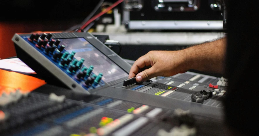 a man working on a sound board in a recording studio, pexels, theatre equipment, multicoloured, touring, thumbnail