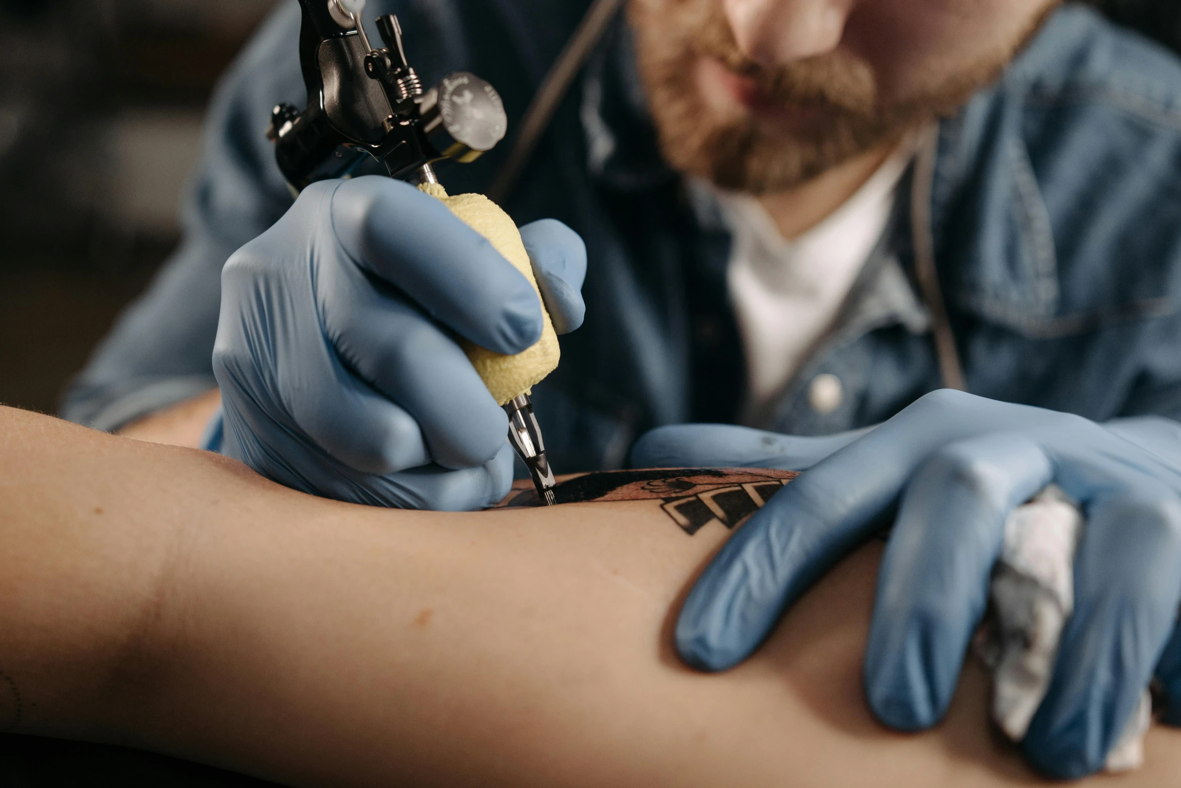 a man getting a tattoo on his arm, trending on pexels, hyperrealism, blue ink, colourised, ilustration, local conspirologist