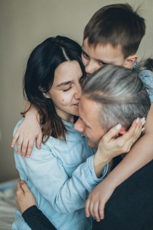 a couple of people that are hugging each other, pexels, incoherents, portrait of family of three, lgbtq, going gray, ignant