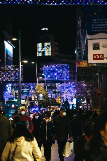 a crowd of people walking down a street at night, led display, seoul, thumbnail, holiday season