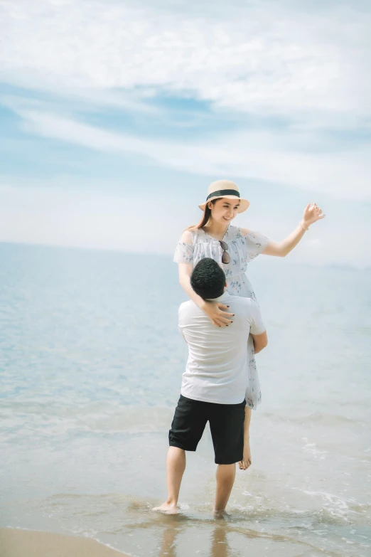 a woman holding a child on the beach, unsplash, romanticism, couple dancing, sunny day with clear sky, ruan jia and brom, video