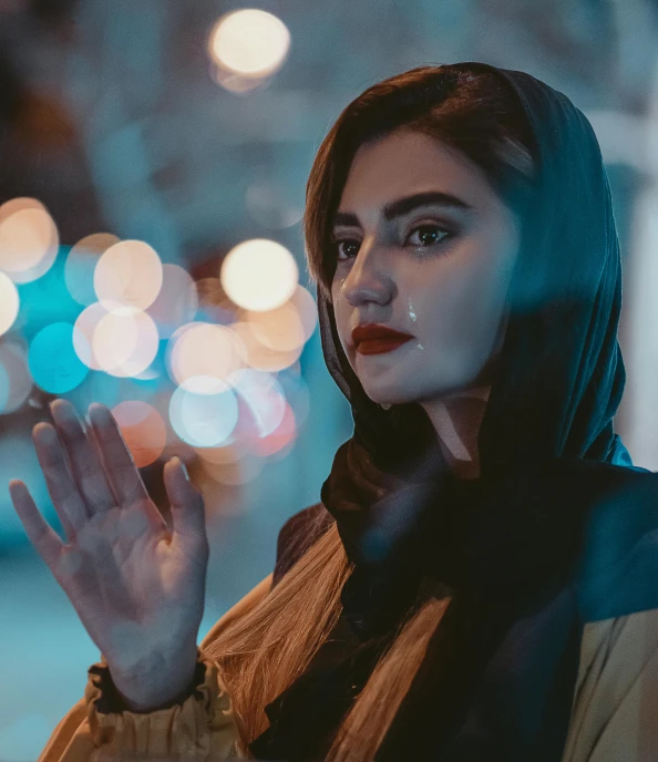 a woman standing on a city street at night, by Maryam Hashemi, trending on pexels, solemn gesture, close up portrait photo, shrugging, 8k hq