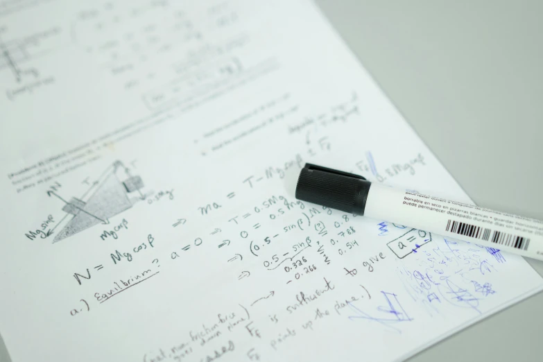 a pen sitting on top of a piece of paper, formulae, whiteboard, taken with sony alpha 9, up close image