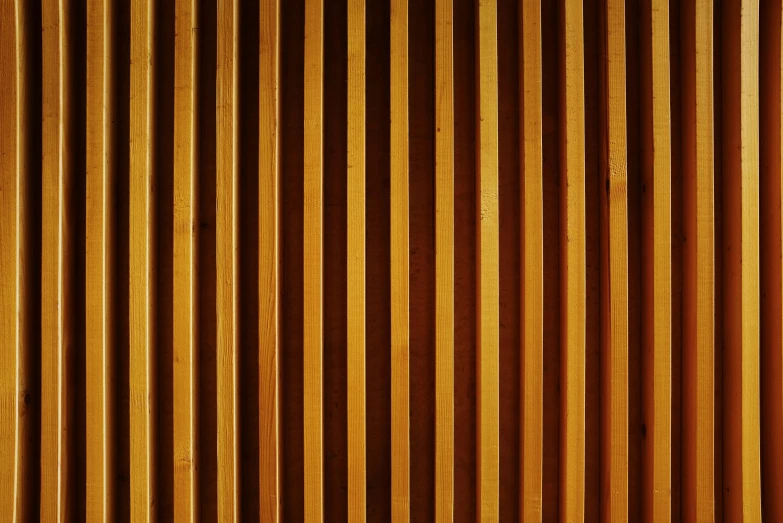 a close up of a wooden wall with vertical lines, inspired by Andreas Gursky, pexels, abstract illusionism, warm golden backlit, detailed medium format photo, pipe organ, in a wooden box. top down photo