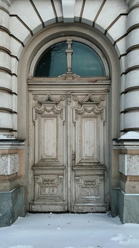 a white fire hydrant sitting in front of a wooden door, by Christopher Wren, baroque, stalinist architecture, kris kuksi, patina, massive decorated doors