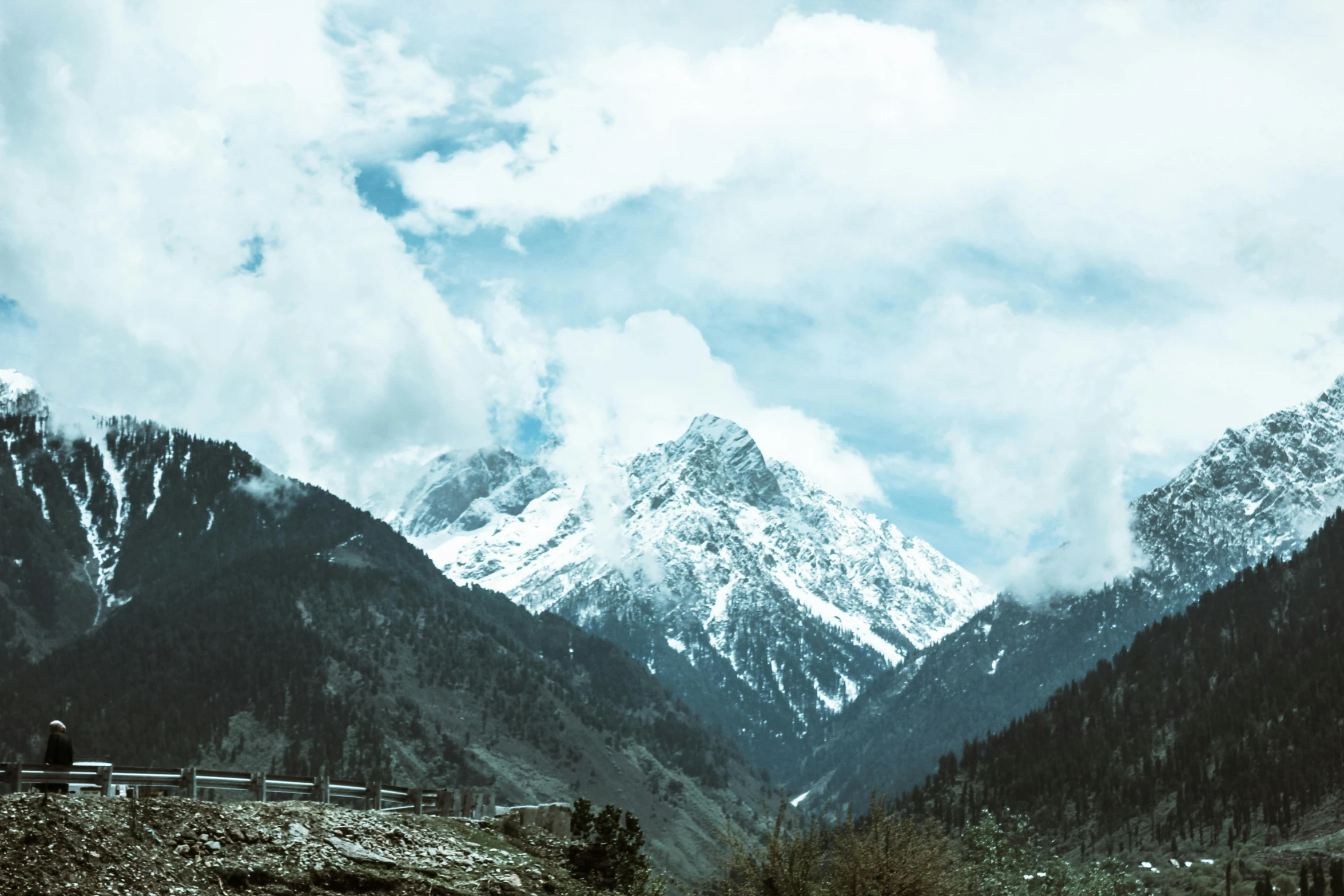 a train traveling down a train track next to a mountain, an album cover, by Muggur, pexels contest winner, hurufiyya, breathtaking himalayan landscape, mountain snow, landslides, wide views