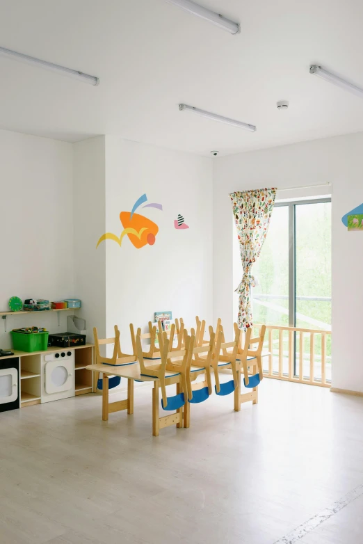 a room that has a table and chairs in it, inspired by Liu Haisu, unsplash, children playground, full room view, square, school of fishes