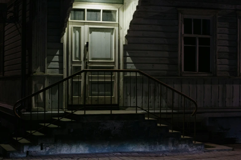 a black fire hydrant sitting in front of a house, inspired by Gregory Crewdson, pexels contest winner, hyperrealism, doorway, stairs, moonlight, brown