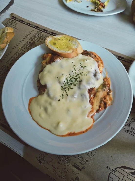 a table topped with plates of food covered in gravy, a photo, by Carey Morris, pexels contest winner, renaissance, buenos aires, cheesy, thumbnail, gray