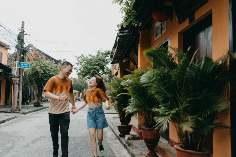 a man and a woman walking down a street, pexels contest winner, in style of lam manh, graphic tees, delightful surroundings, avatar image