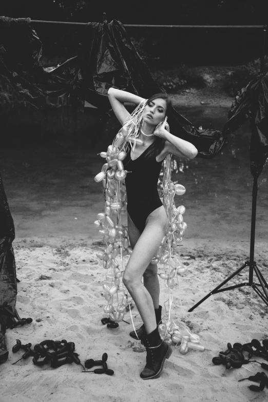 a black and white photo of a woman in a bathing suit, tumblr, conceptual art, party in jungles, wrapped in cables and flowers, pr shoot, ✨🕌🌙