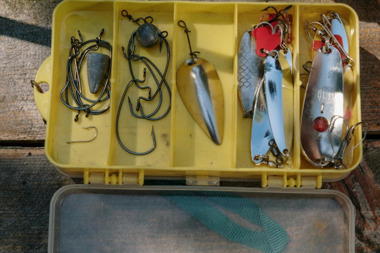 a box filled with different types of fishing equipment, by Bradley Walker Tomlin, pexels, assemblage, avatar image, yellow, cel shad