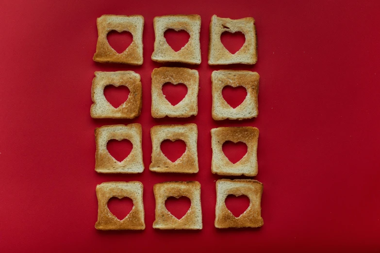 heart shaped pieces of toast on a red surface, pexels, squares, 1 2 9 7, 6 pack, artoast8p