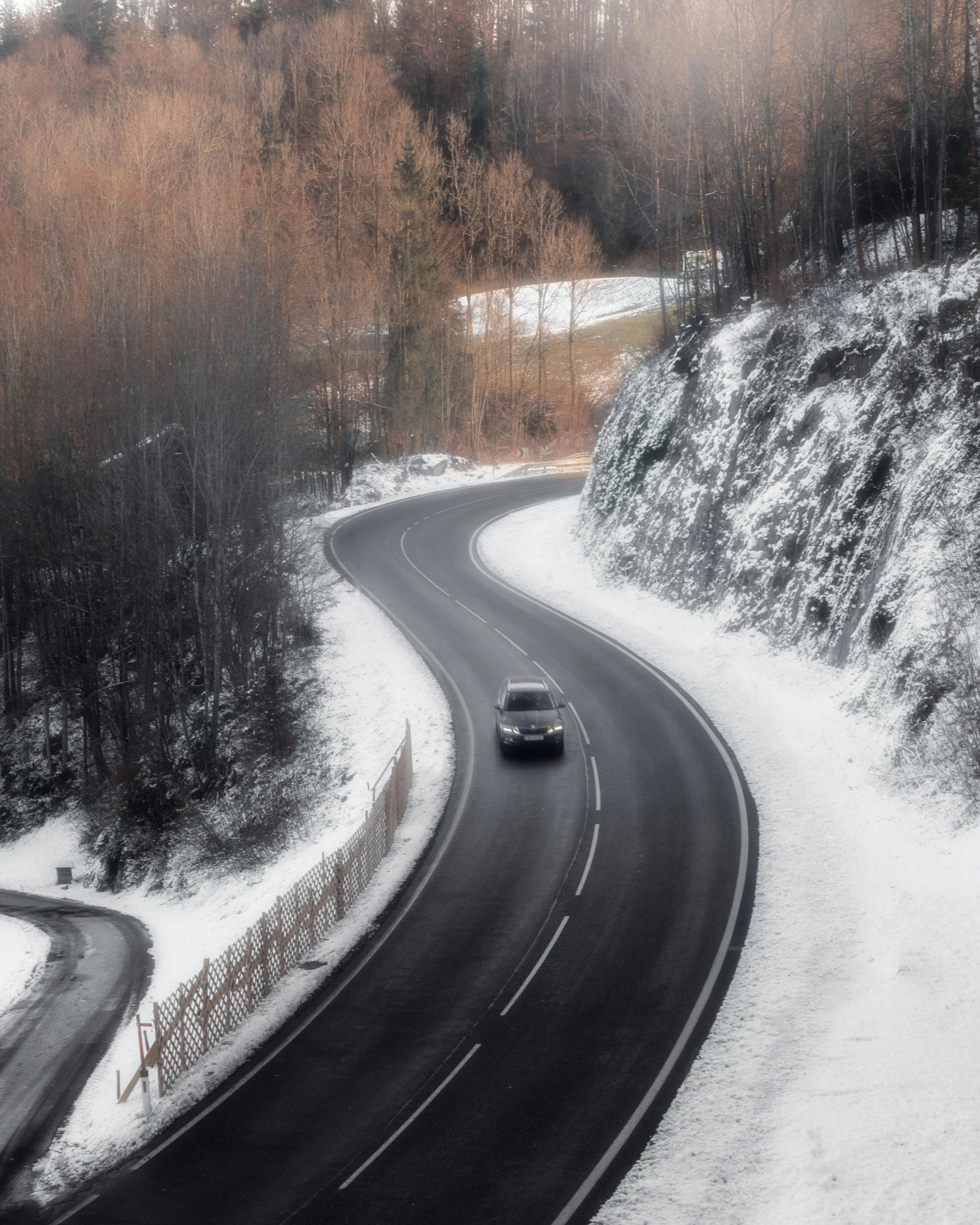 a couple of cars driving down a snow covered road, pexels contest winner, showing curves, lgbtq, white and grey, alpine