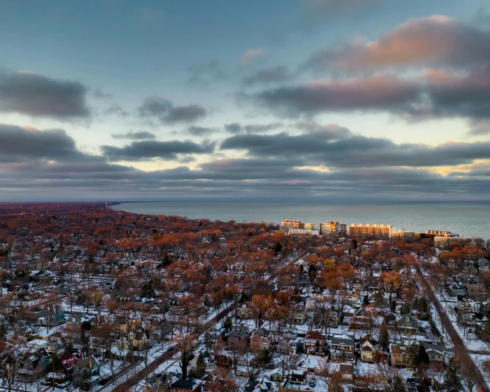 an aerial view of a city with a lake in the background, by Carey Morris, unsplash contest winner, overcast dusk, winter setting, from wheaton illinois, seaview