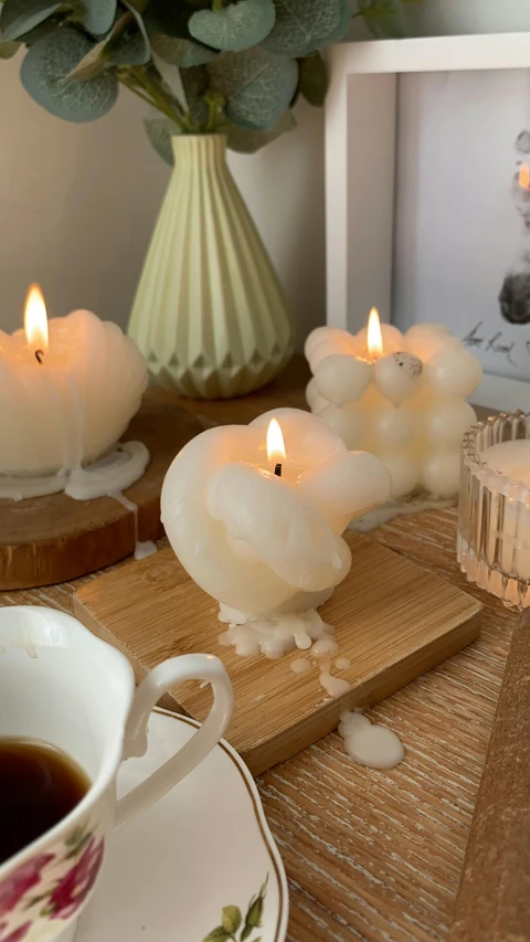 a cup of coffee and some candles on a table, jellyfish phoenix head, carved in white marble, 3d product, medium-shot