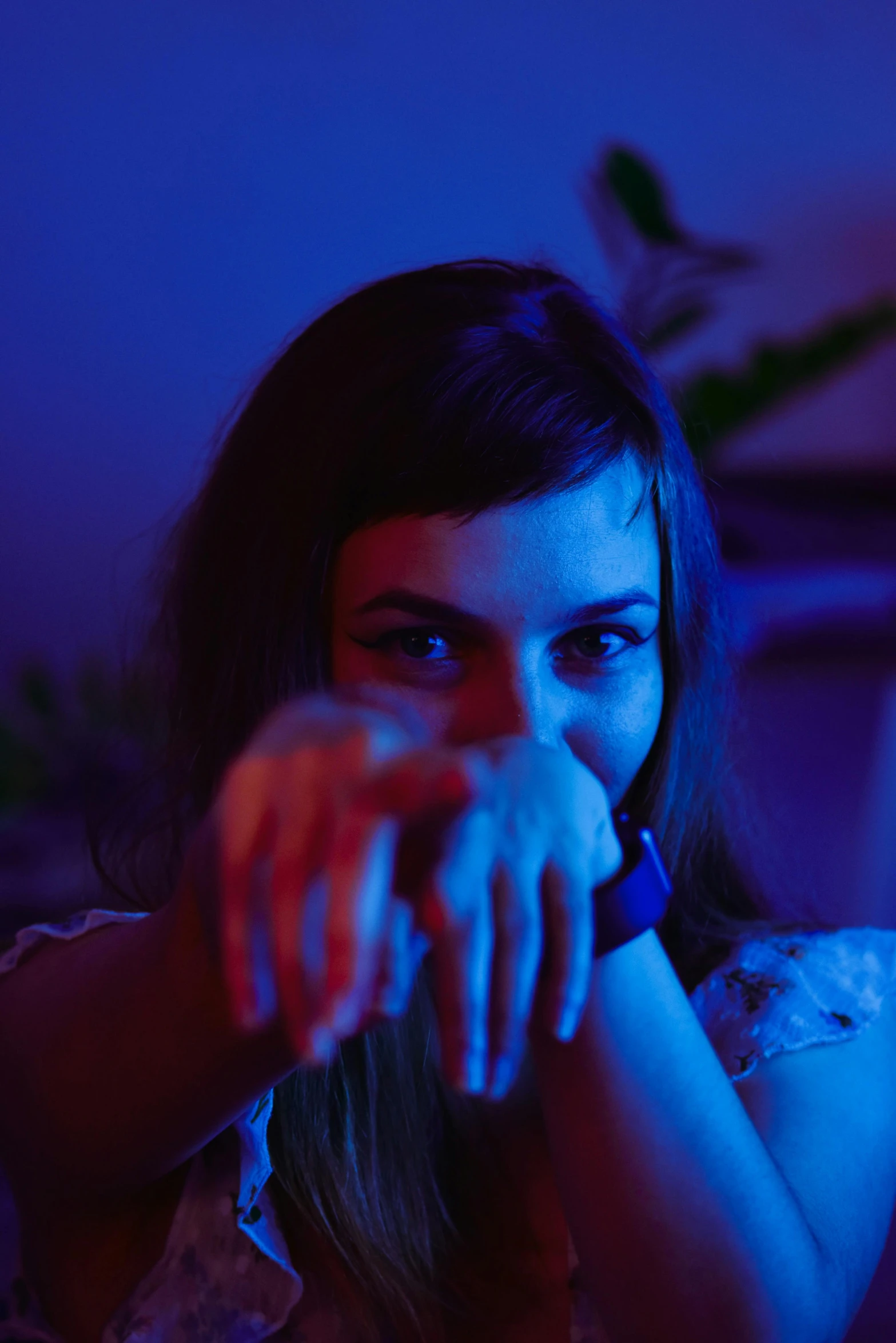 a woman sitting in front of a laptop computer, a picture, inspired by Elsa Bleda, blue lights and purple lights, hand on her chin, portrait sophie mudd, 35mm —w 1920 —h 1080