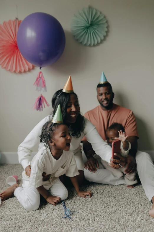 a family poses for a picture at a birthday party, pexels contest winner, conceptual art, jaylen brown, dwell, cone, color footage