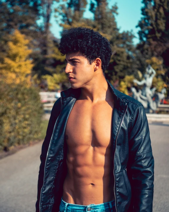 a shirtless young man standing on the side of a road, trending on pexels, renaissance, curly black hair, wearing a fancy black jacket, physical : tinyest midriff ever, lgbtq