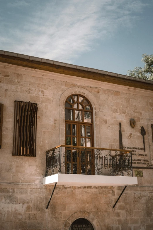 a building with a balcony and a balcony, by Riad Beyrouti, pexels contest winner, arabesque, cyprus, museum background, exterior view, storefront